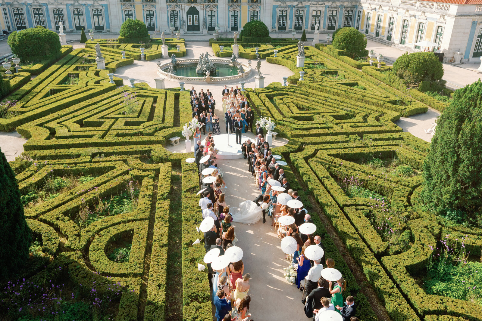 Vertical aerial view of the couple exiting the ceremony aisle
