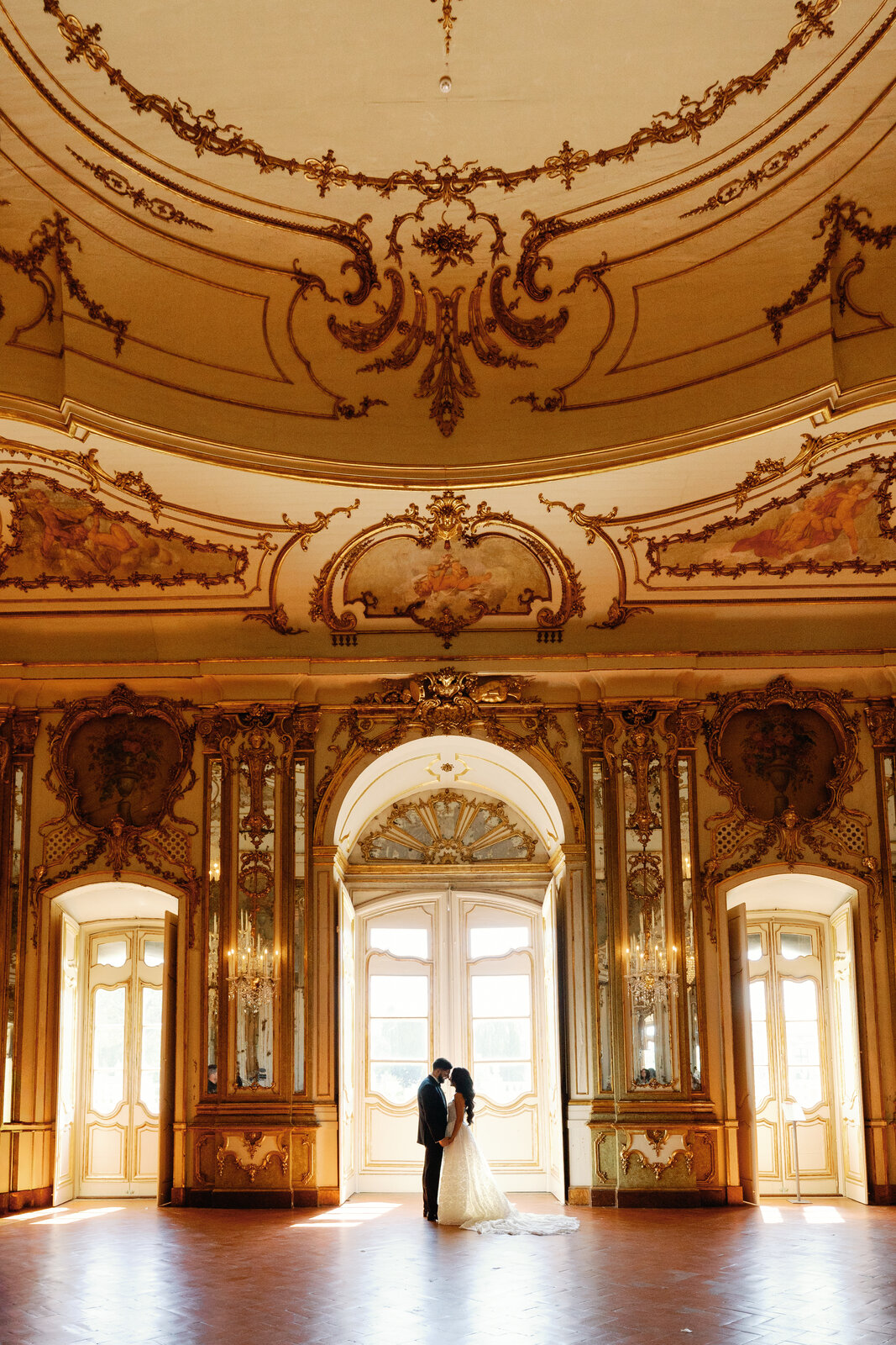 Bride and groom silhouetted in the ballroom doorway
