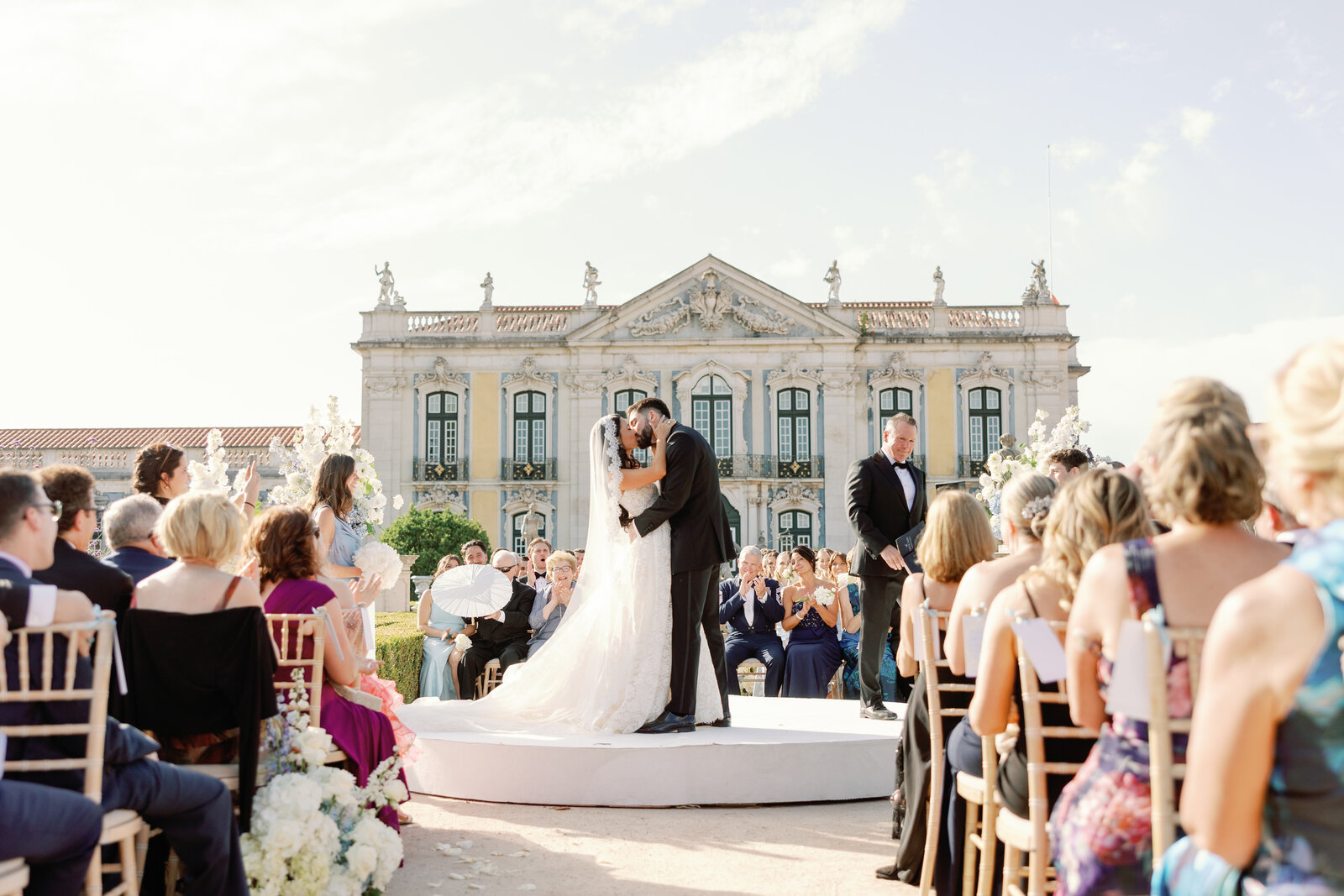 Bride and groom's first kiss as guests applaud