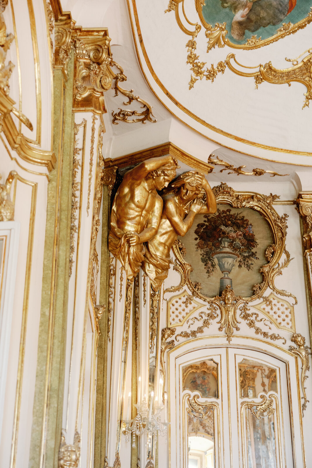 Detail of the gilded ceiling and painted panels in the ballroom