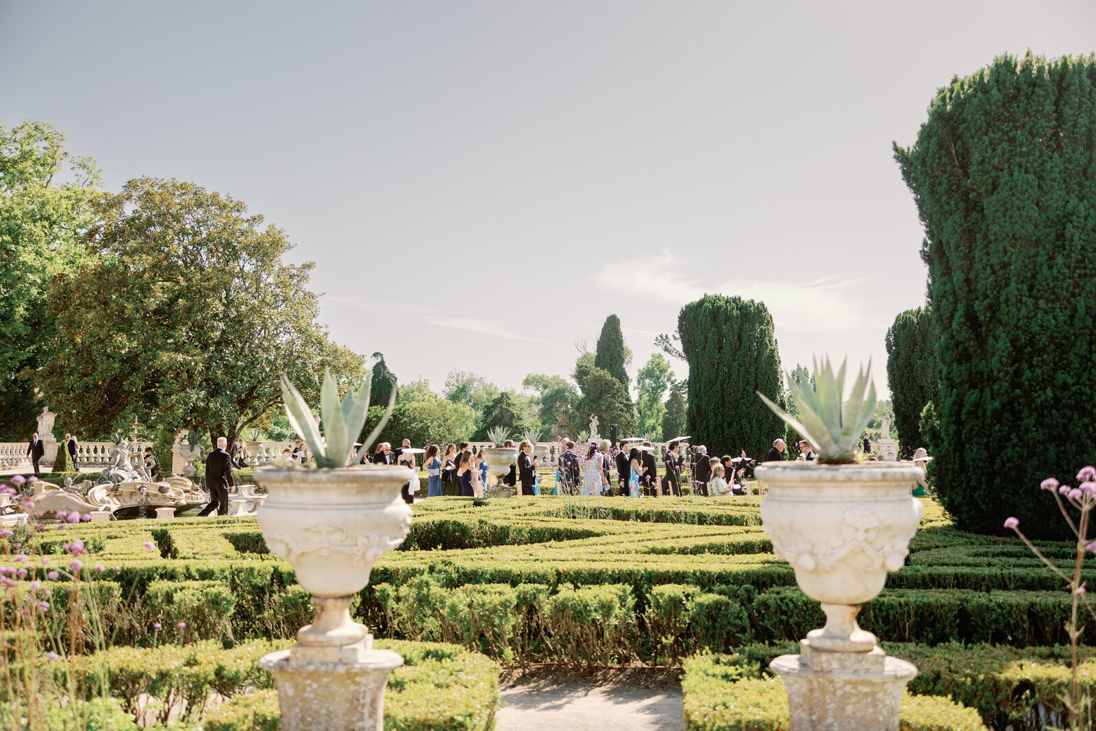 Guests strolling past the palace with white parasols