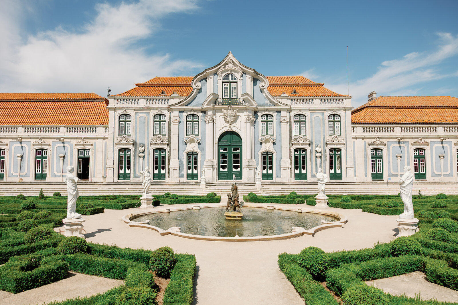 Palace facade with fountain and formal garden