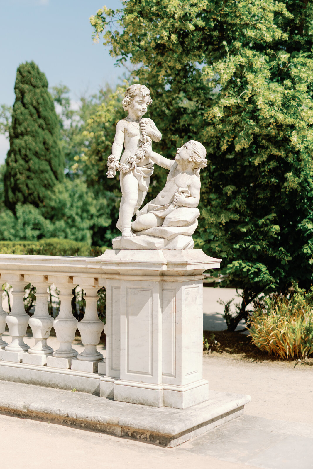 Stone cherub statue atop the garden balustrade