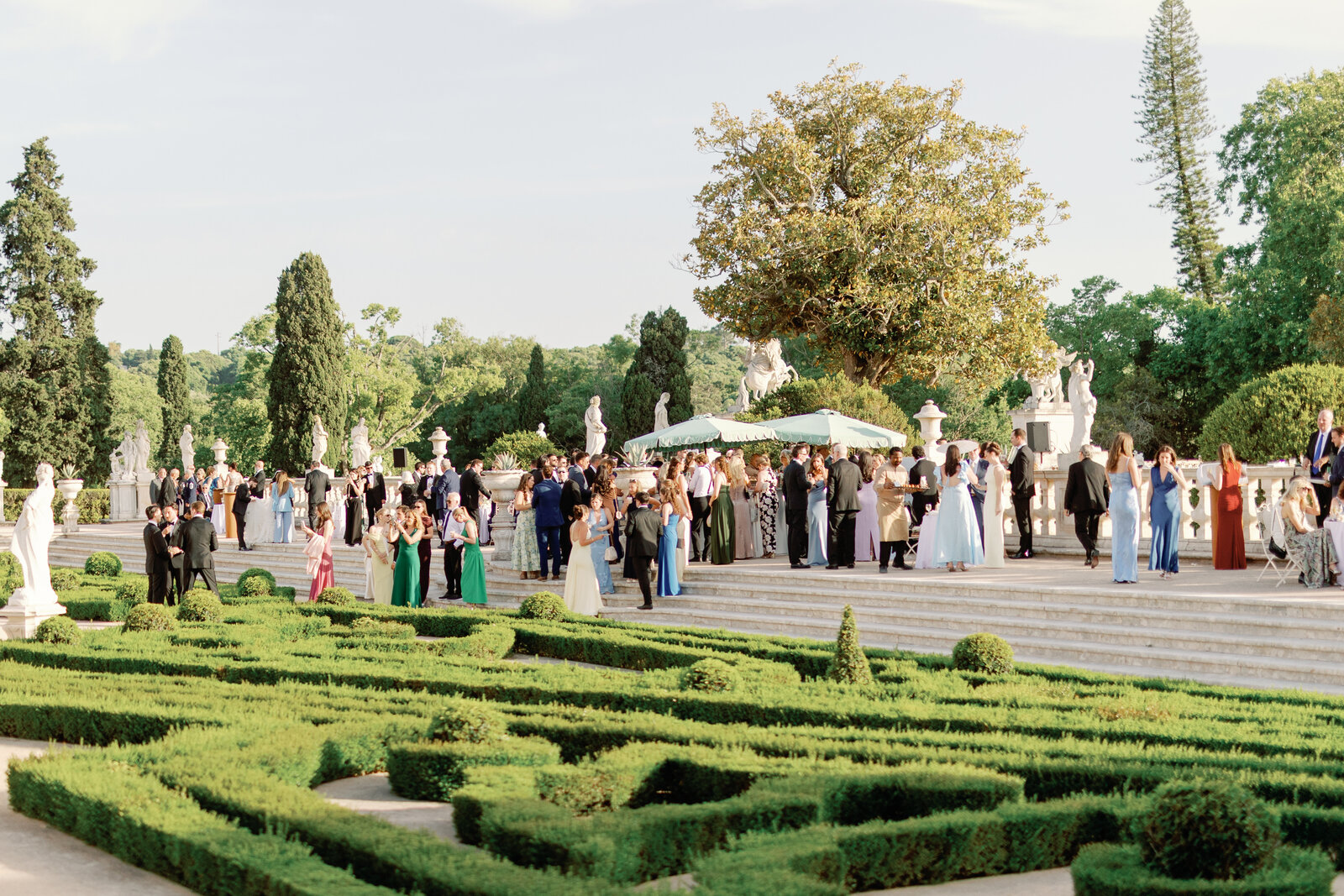 Boxwood parterre garden with central fountain and lounge seating