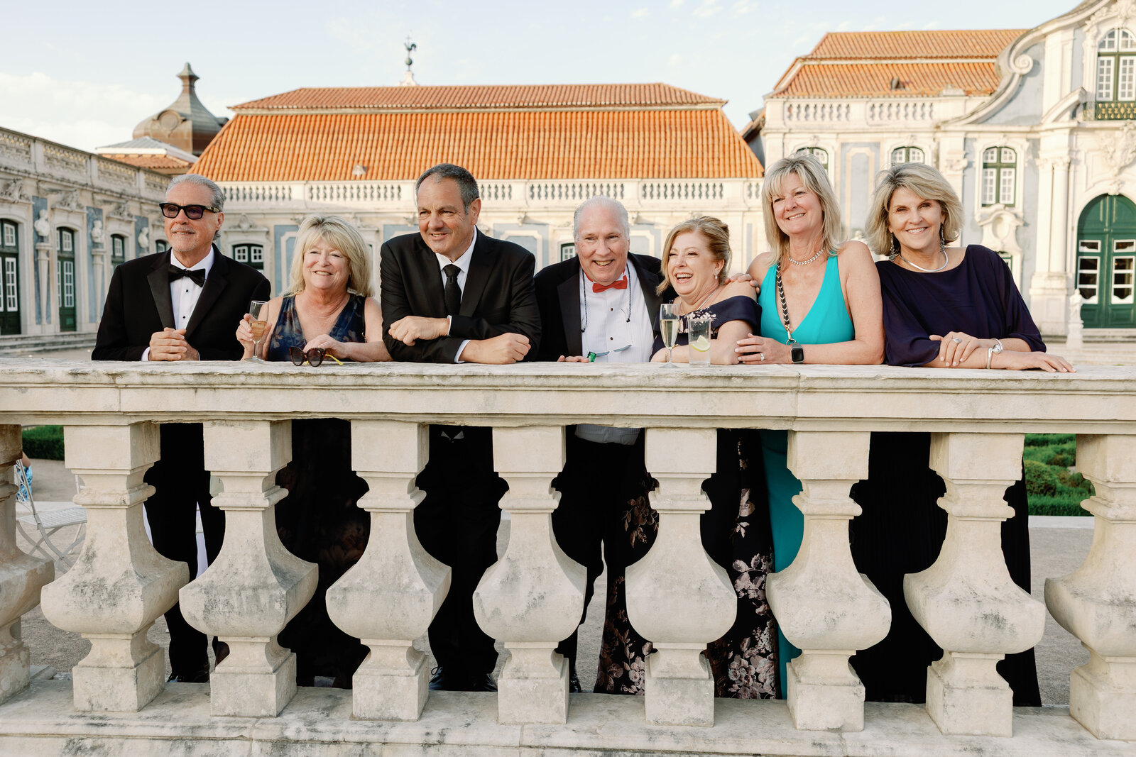 Group of guests toasting together at the palace balustrade