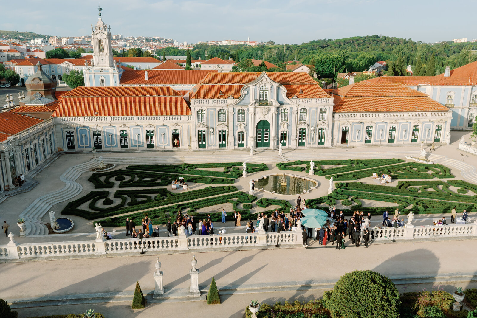 Group portrait of guests in evening wear on the terrace