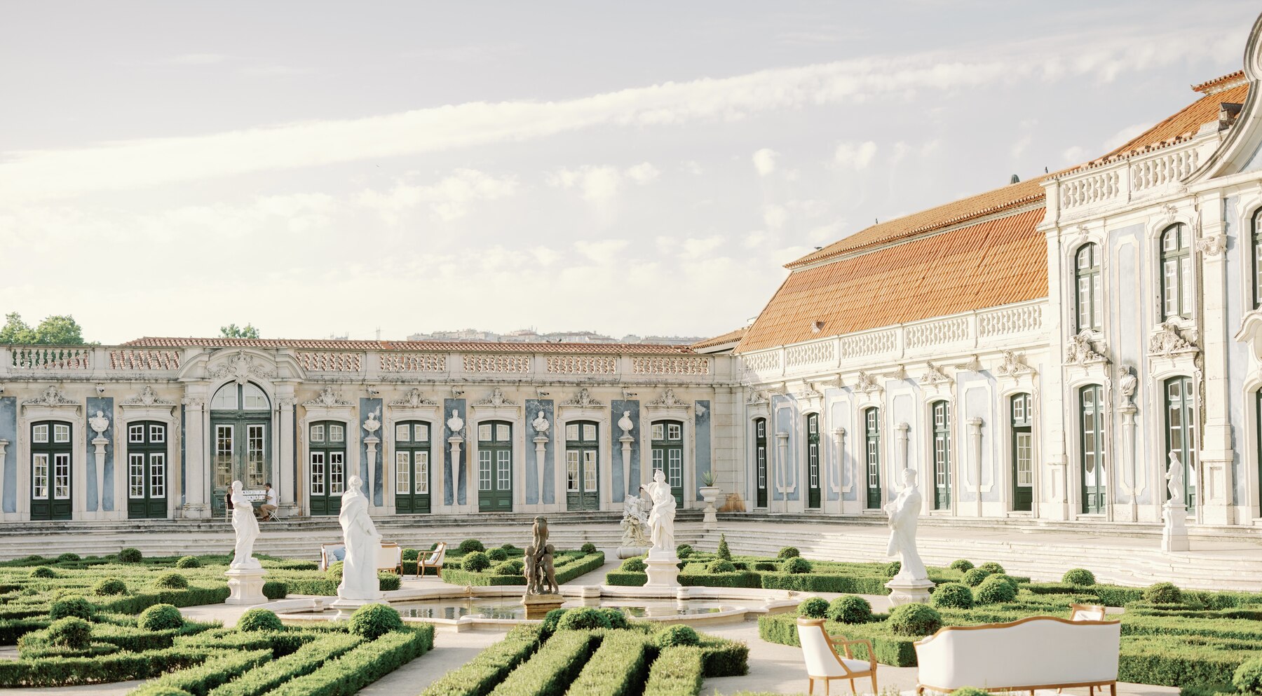 Palácio de Queluz garden courtyard with fountain and lounge seating