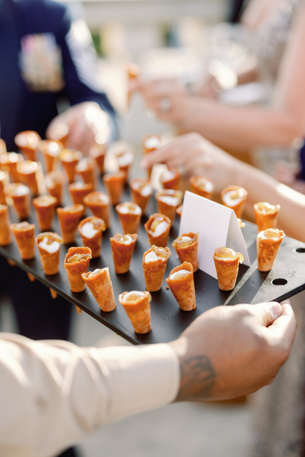 Close-up of passed savory cones on a black serving board