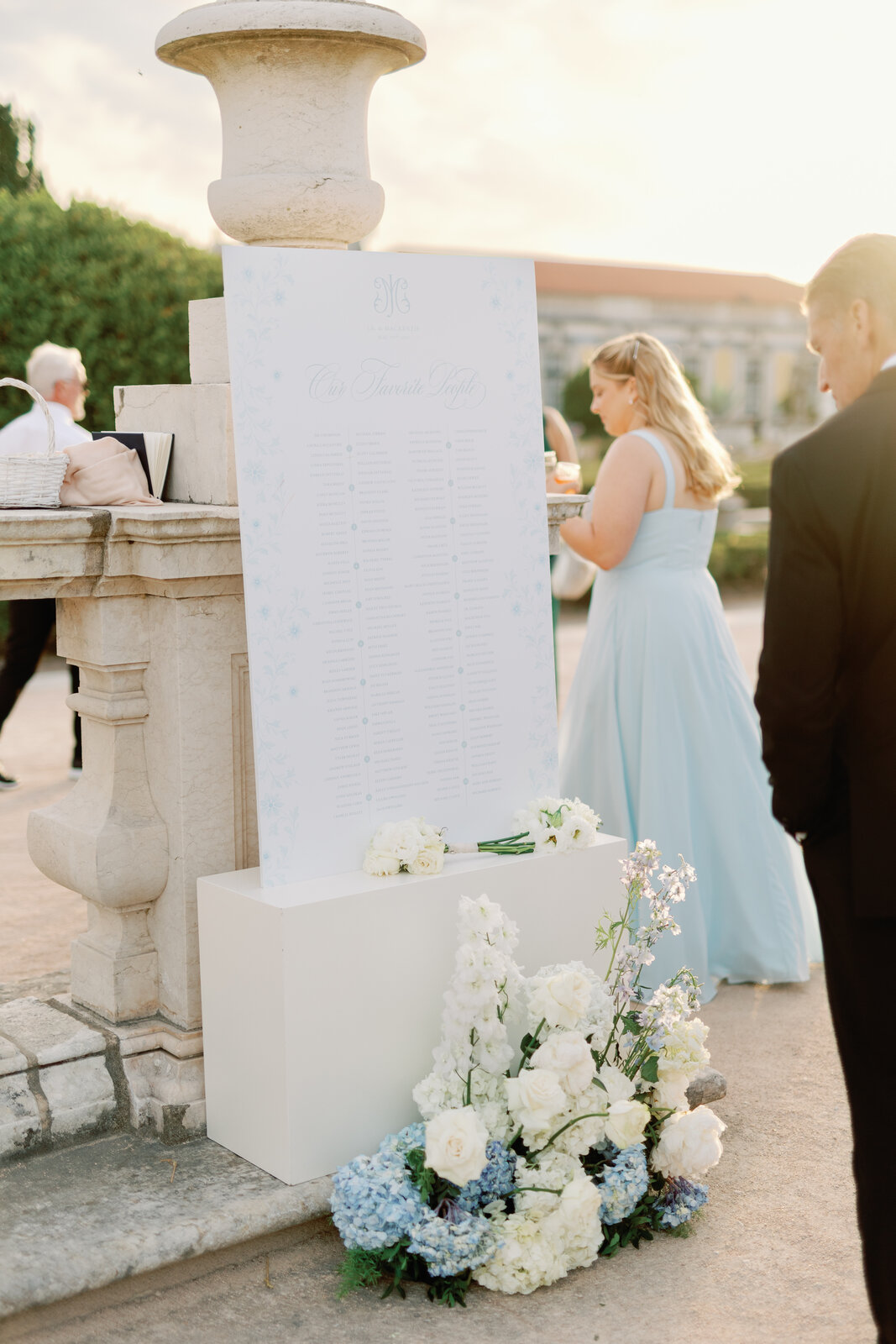Our Favorite People seating chart sign with white bouquets