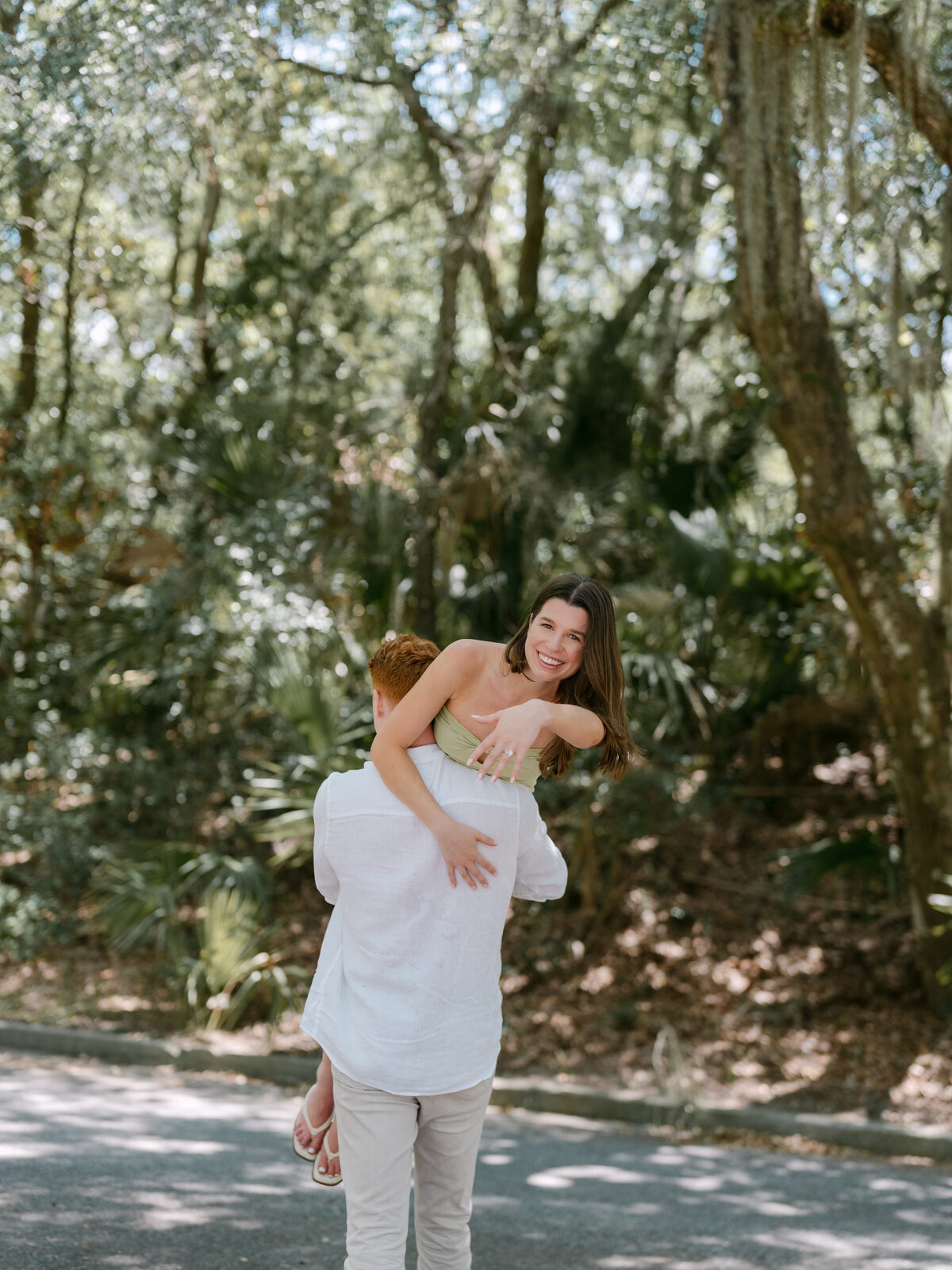 Couple laughing together on a wooded path