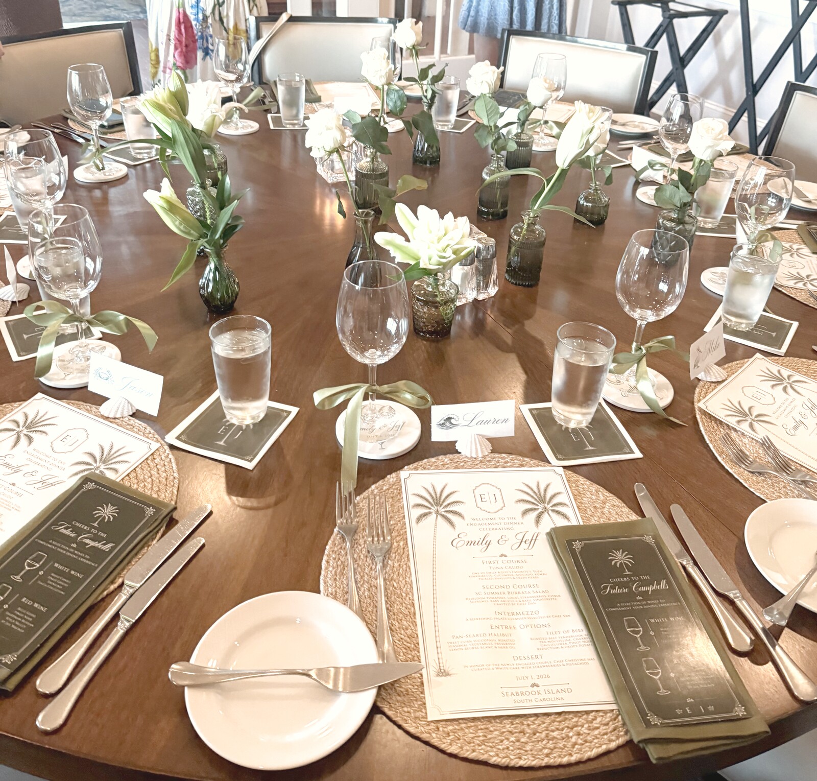 Dinner table set with white roses and ribbon-tied place settings