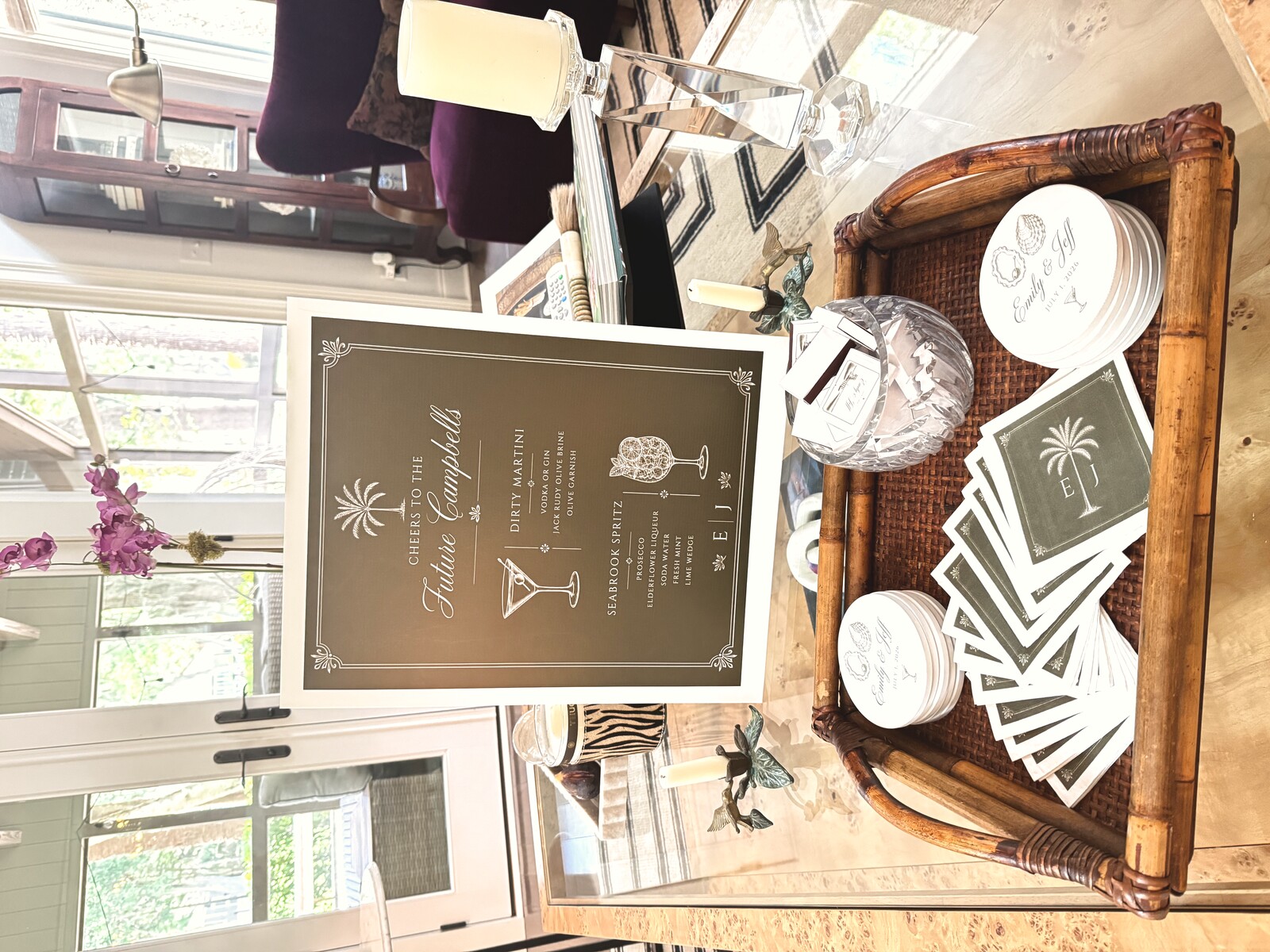 Signature cocktail sign displayed on a bar tray with coasters and matchbooks