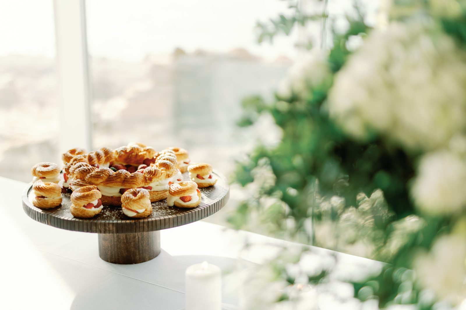 Cream puff pastries arranged on a wooden stand