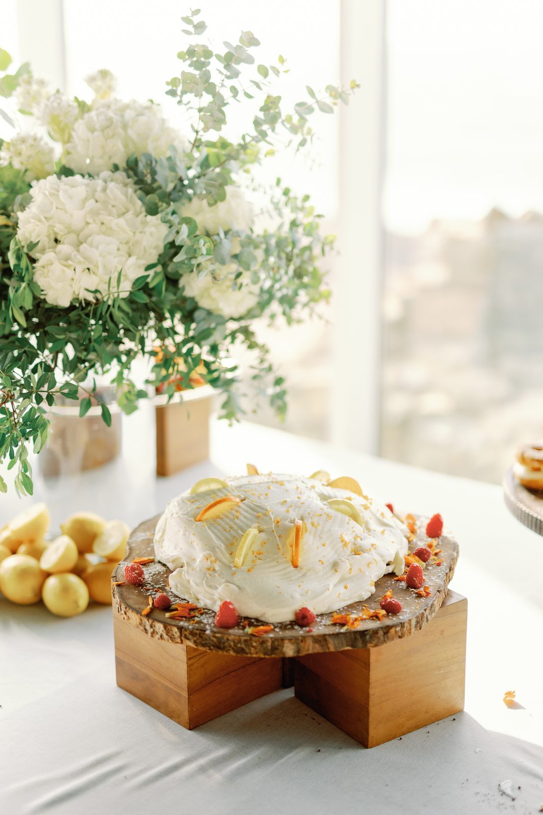 Citrus-topped dessert on a wooden cake stand