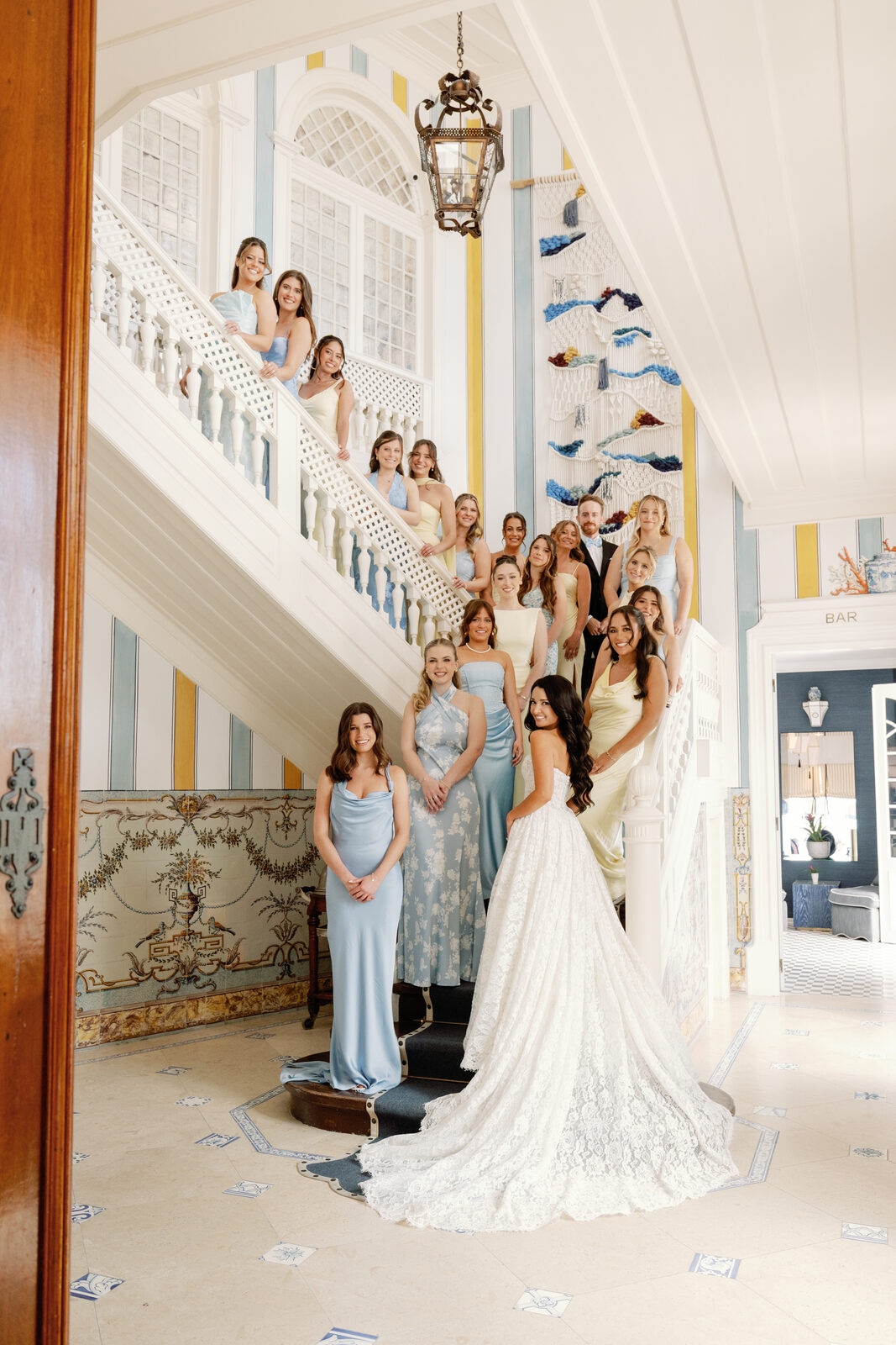 Bride descending the staircase in her wedding gown