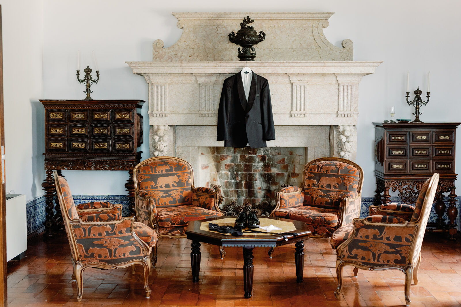 Groom's tuxedo jacket hanging above the fireplace mantel