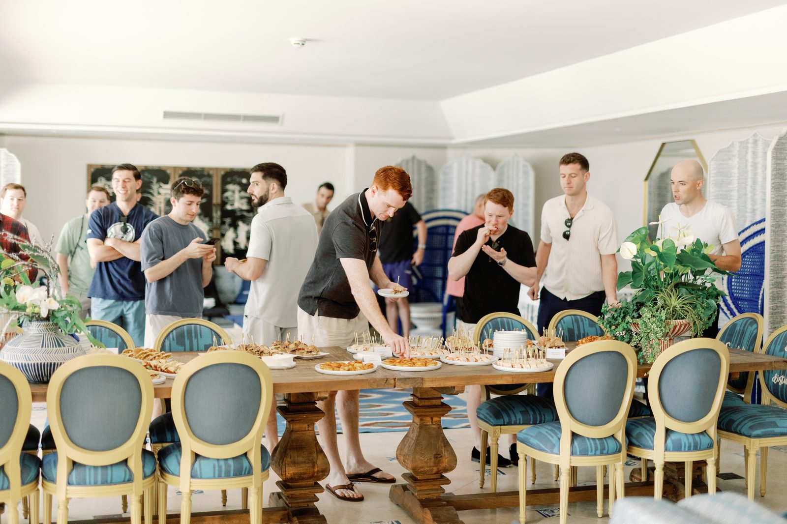 Groomsmen enjoying appetizers before the ceremony