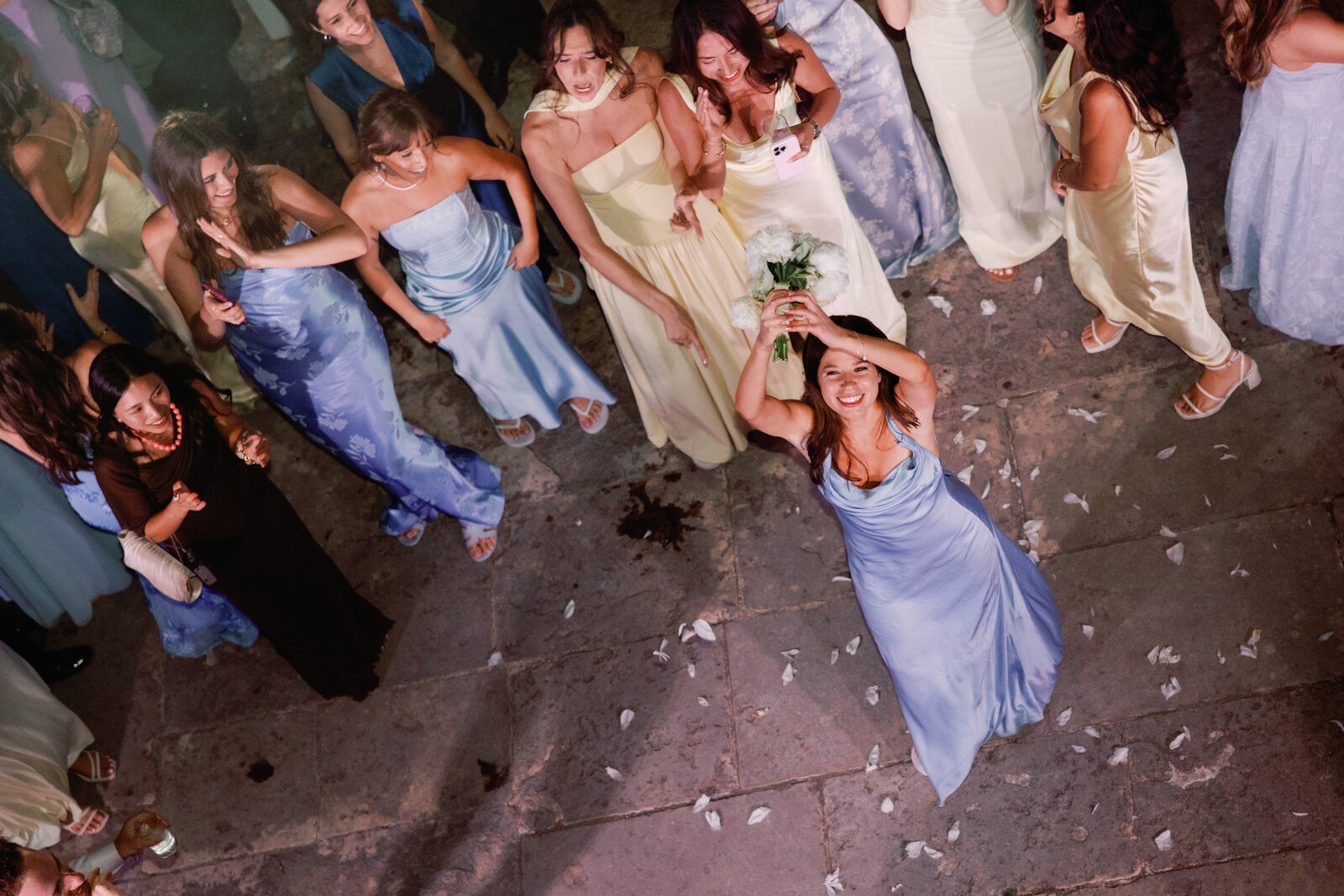 Aerial view of a bridesmaid catching the bouquet toss