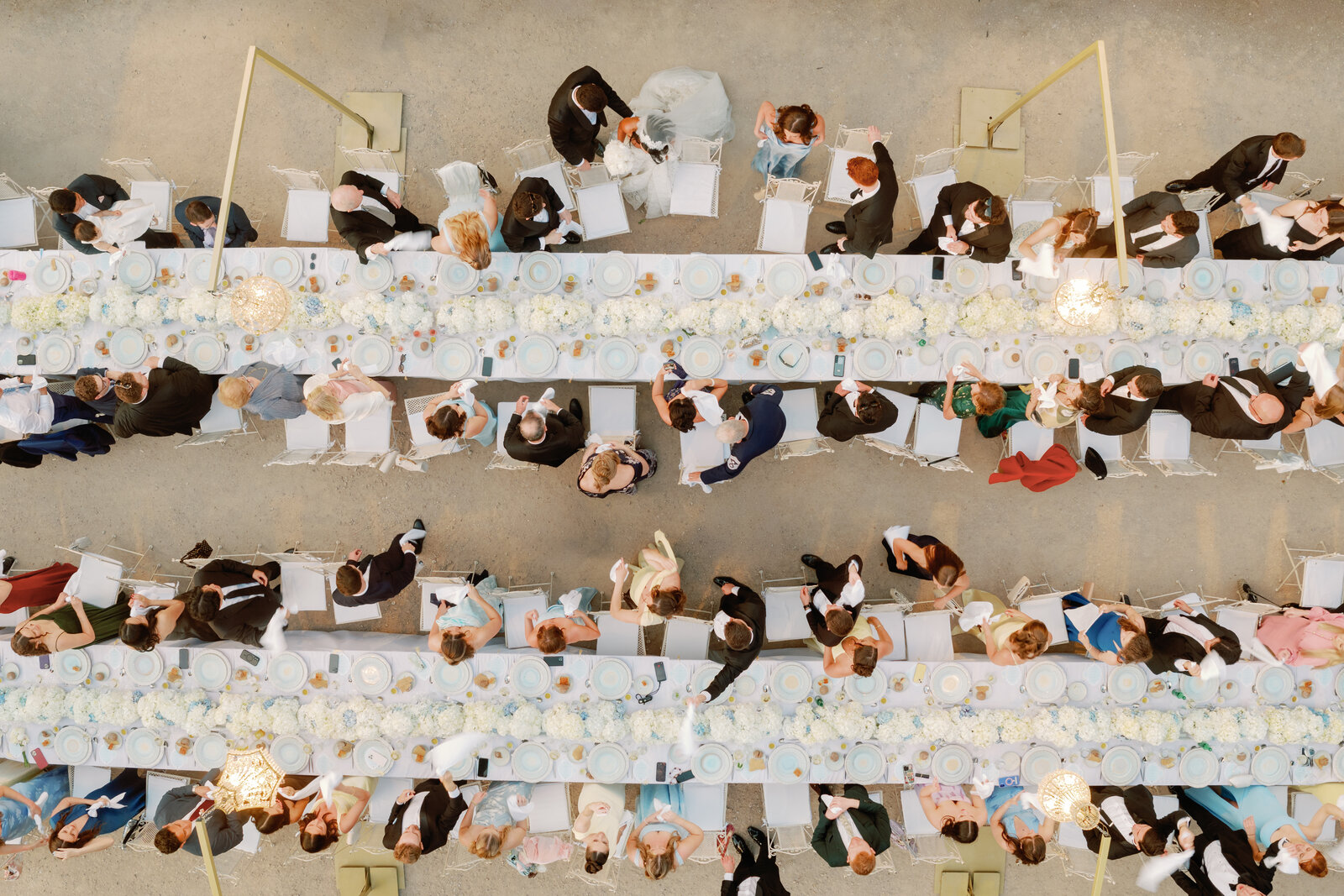 Top-down aerial view of guests seated at the reception tables