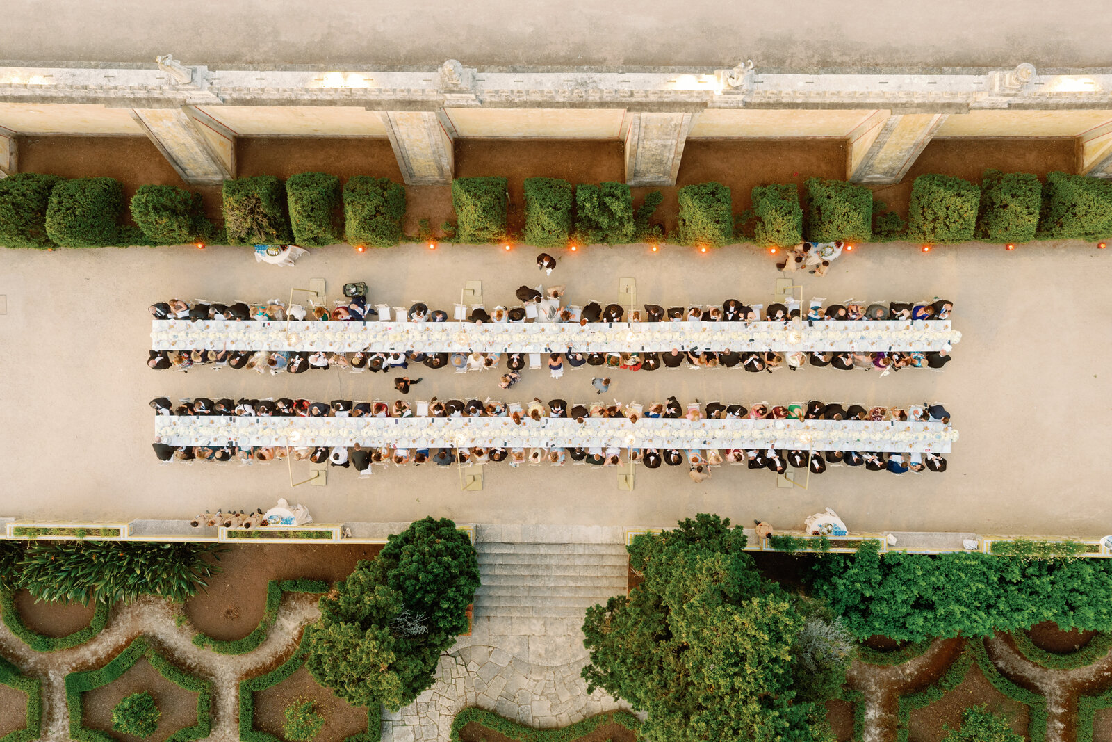 Aerial view of the full length of the reception tables toward the palace