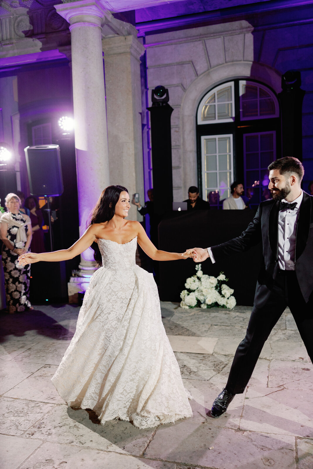 Bride twirling in her lace gown during the first dance