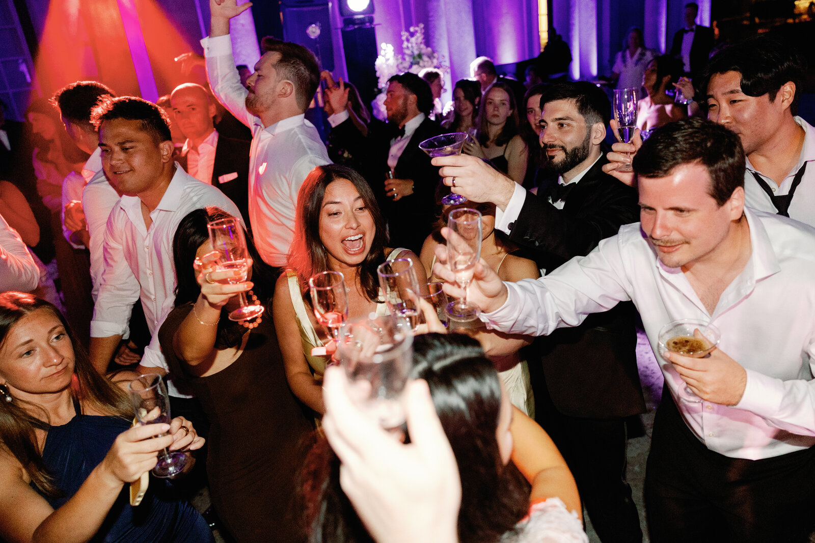 Guests raising champagne glasses together in a toast