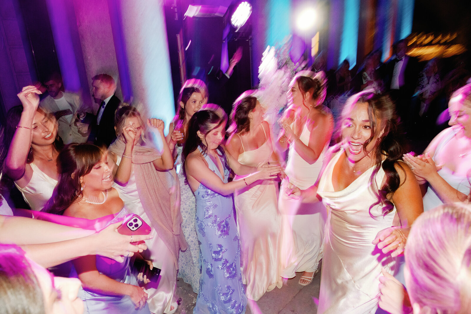 Motion-blurred candid of guests dancing and laughing together