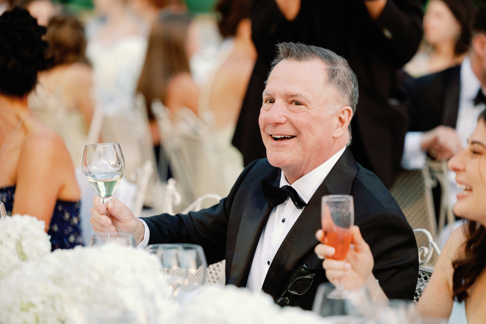 Guest raising a wine glass in a candid toast