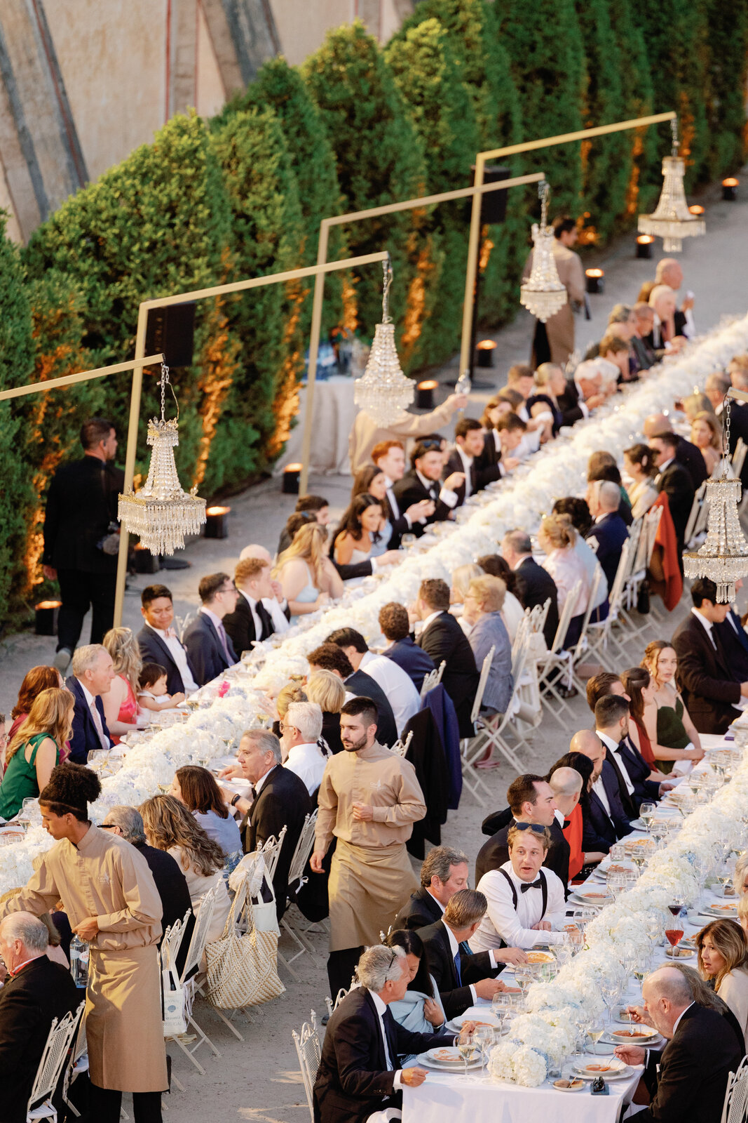 Guests seated and enjoying the meal at the long tables