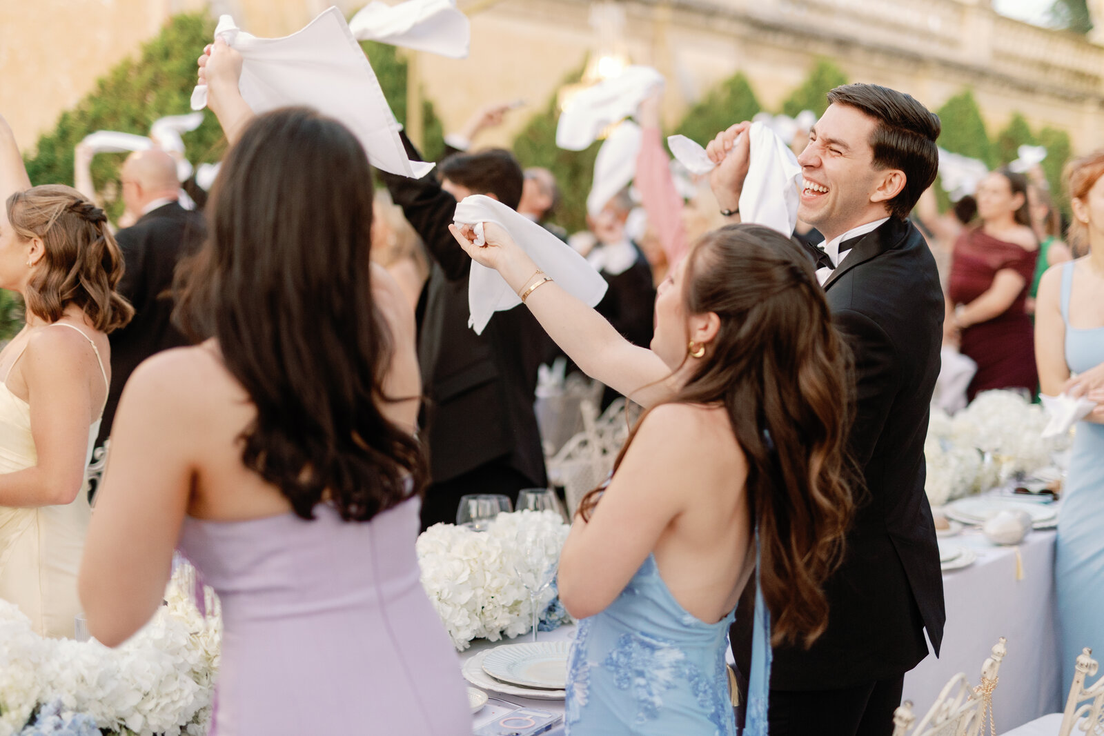 Guests laughing and waving napkins during the send-off
