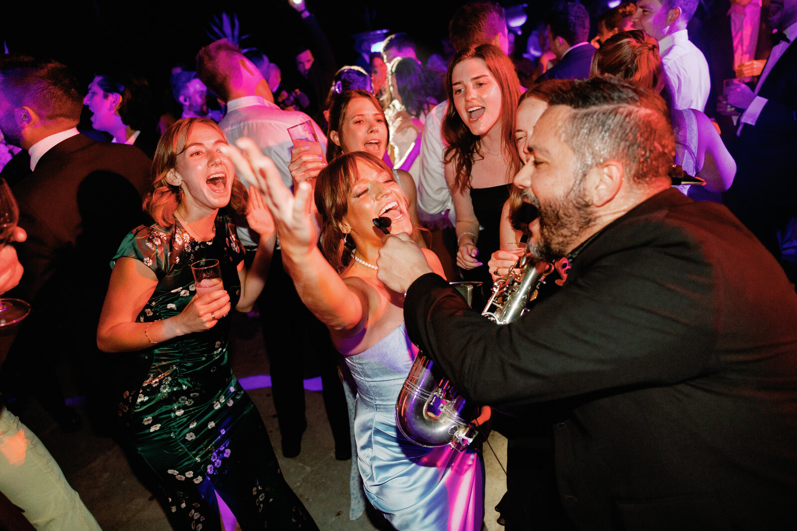 Guests singing along with the saxophonist on the dance floor