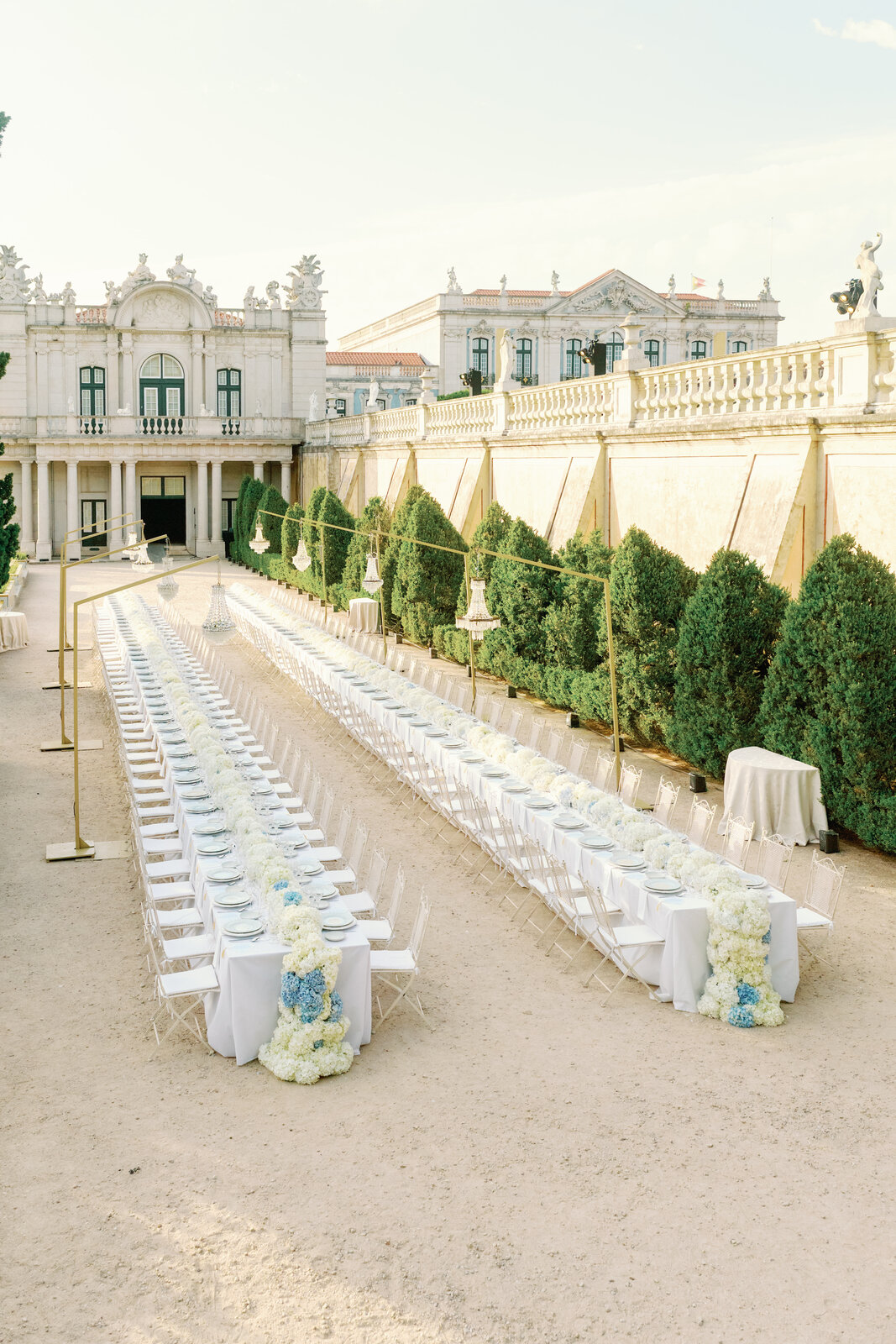 Long banquet tables set along the palace terrace