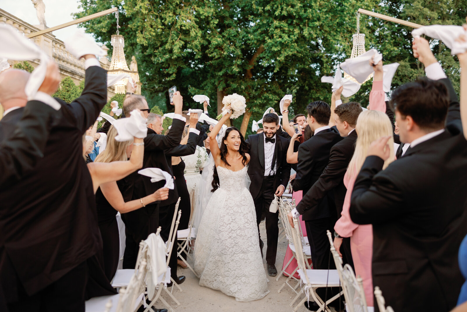 Bride and groom walking through the cheering napkin send-off