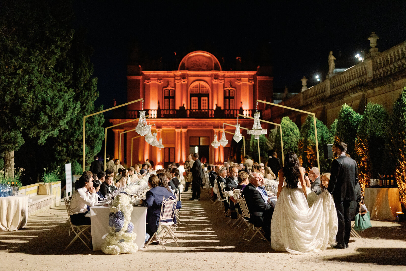 Reception tables at night with the palace lit in warm orange