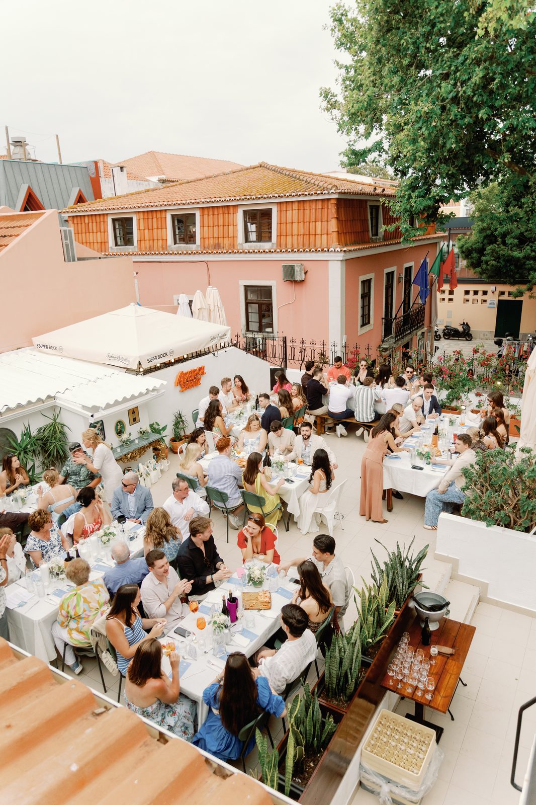 Wide aerial view of guests seated for the rehearsal dinner