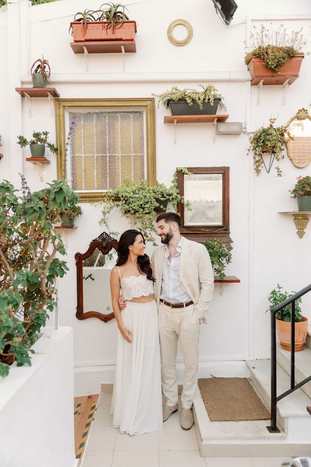 Bride and groom portrait in front of the decorative mirror wall