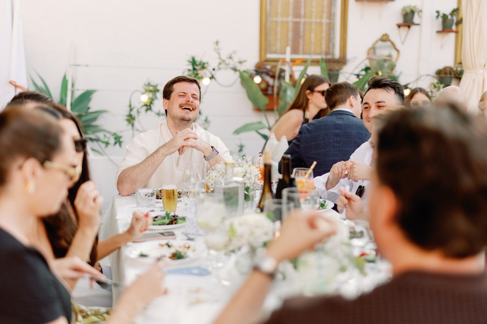 Guest laughing candidly at the dinner table