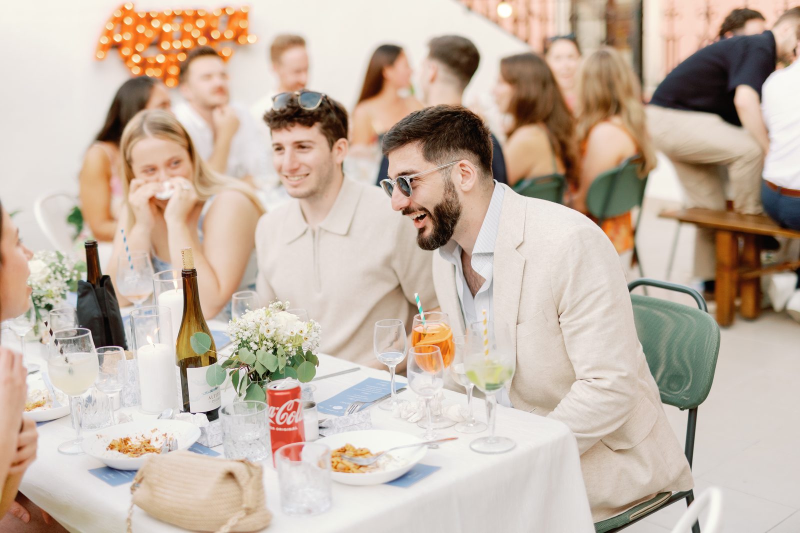 Guests laughing together at the dinner table