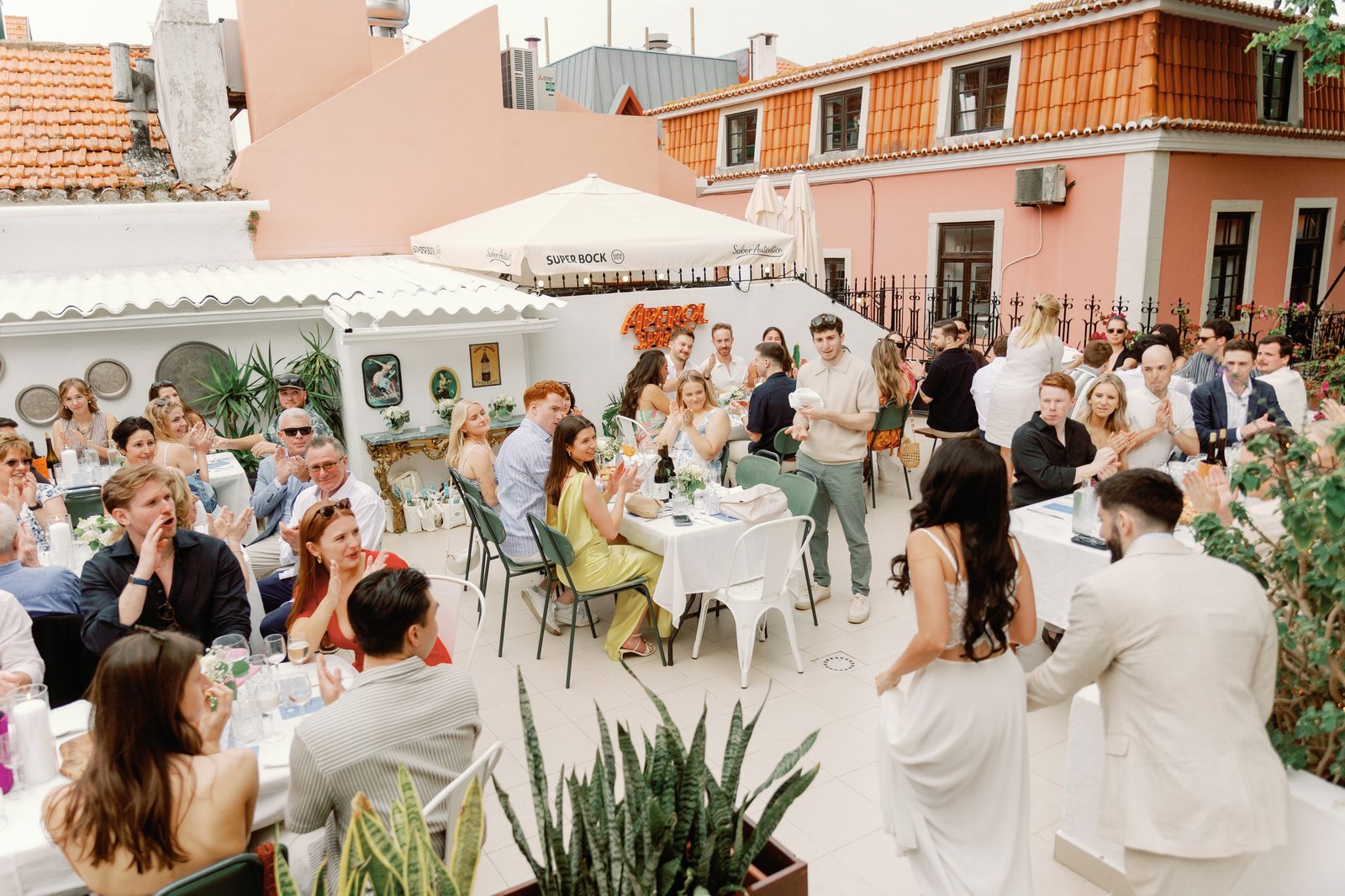 Guests applauding during a toast at the rehearsal dinner