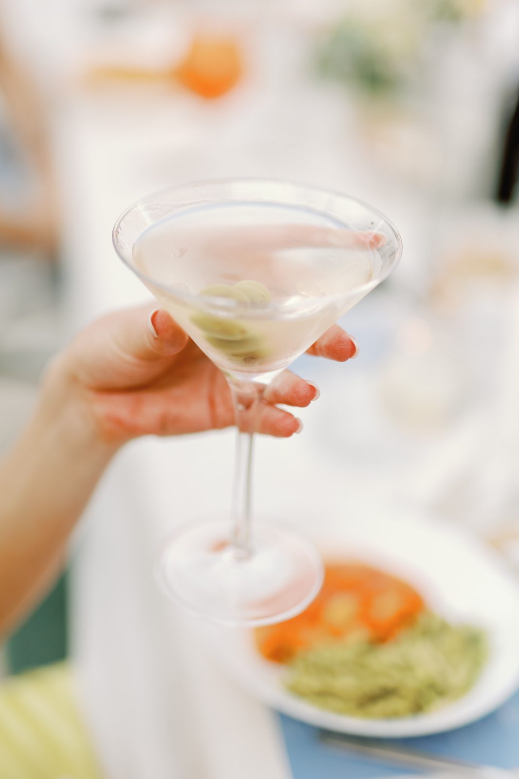 Close-up of a martini garnished with olives