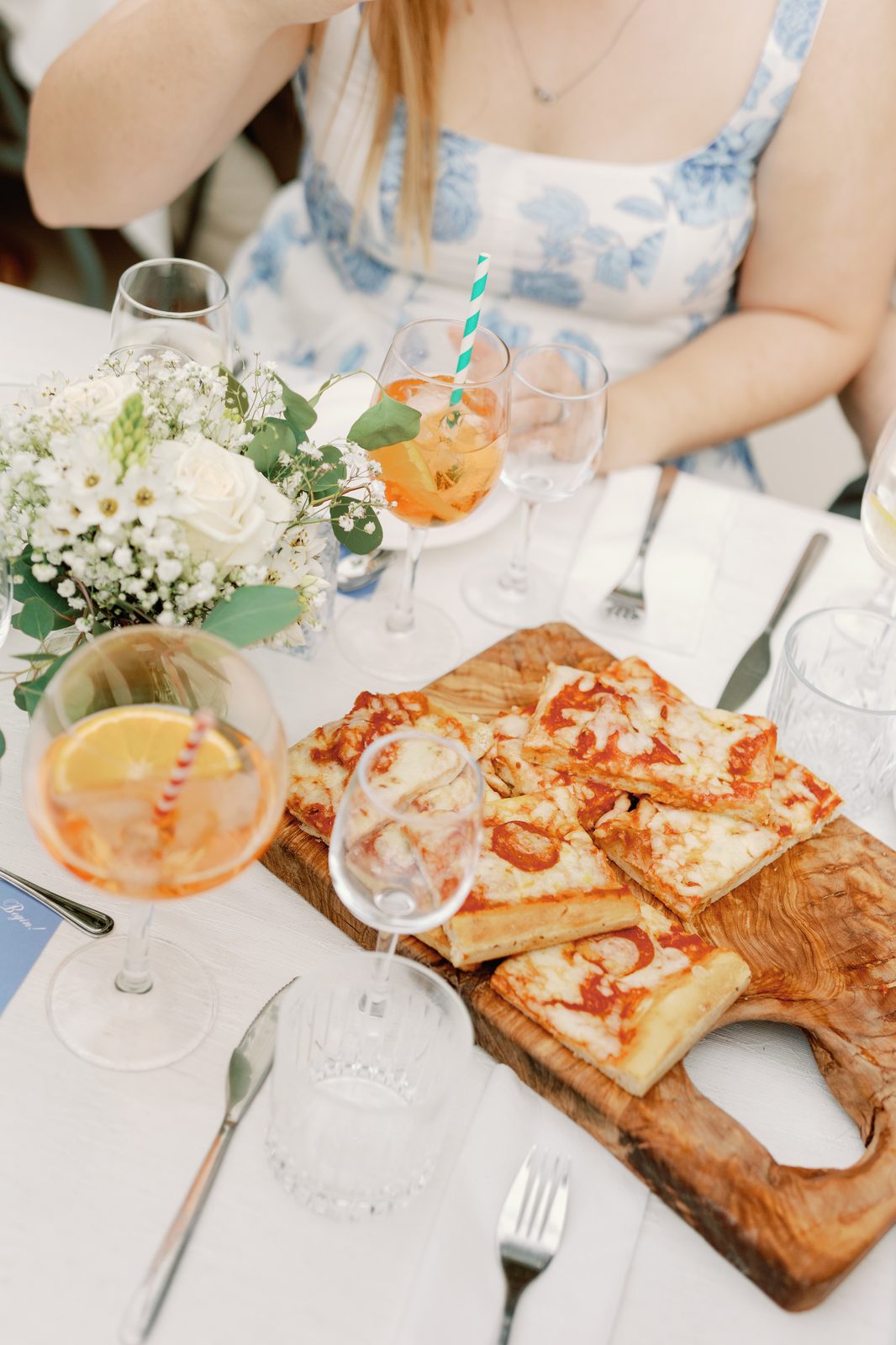 Wood board of pizza with Aperol spritz cocktails