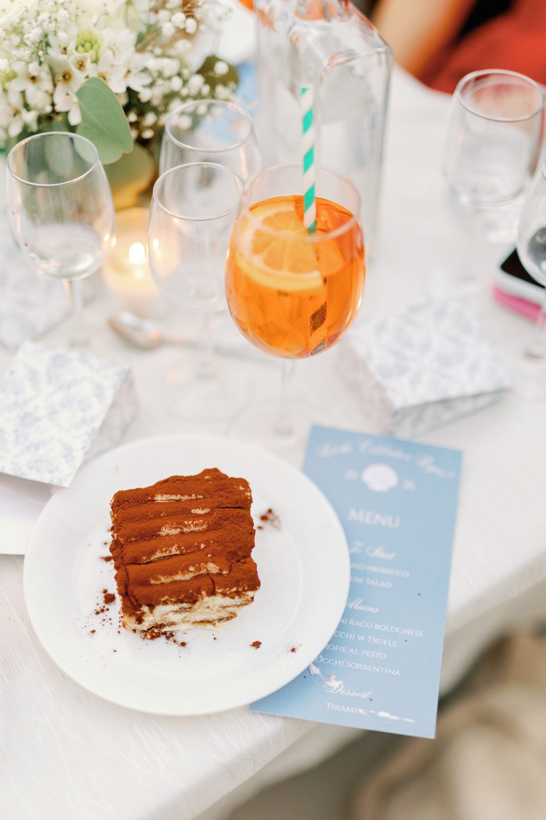 Tiramisu dessert plated next to an Aperol spritz