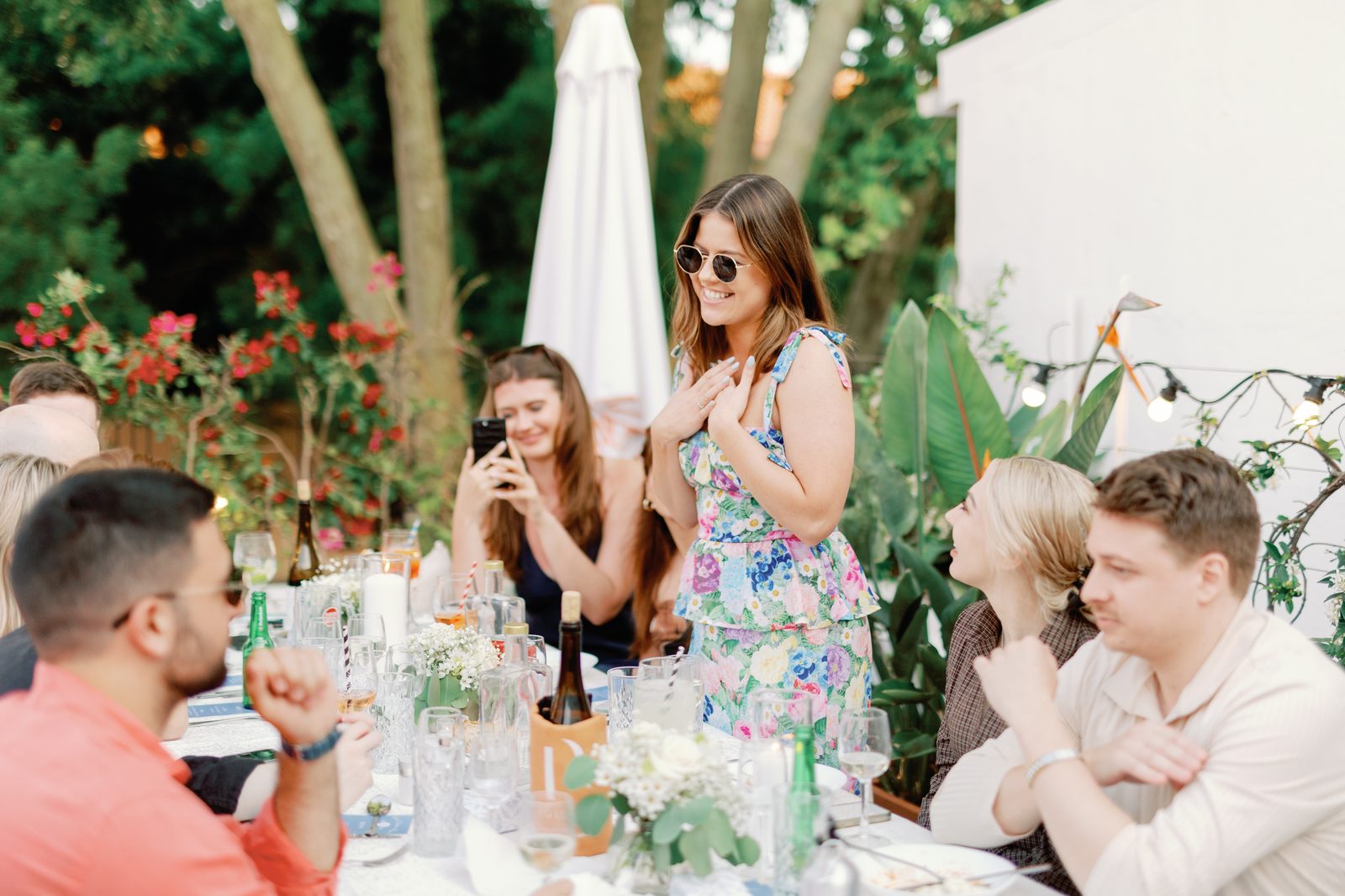 Guest giving a heartfelt toast speech in a floral dress
