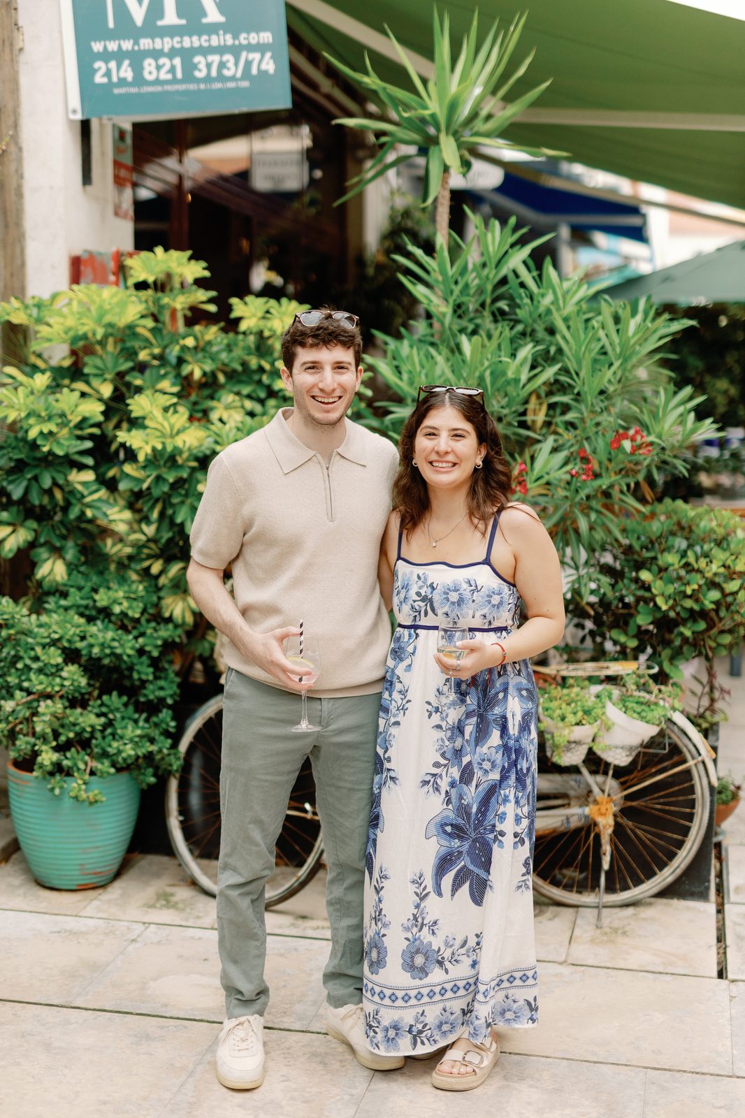 Couple posing together outside a shop in Cascais