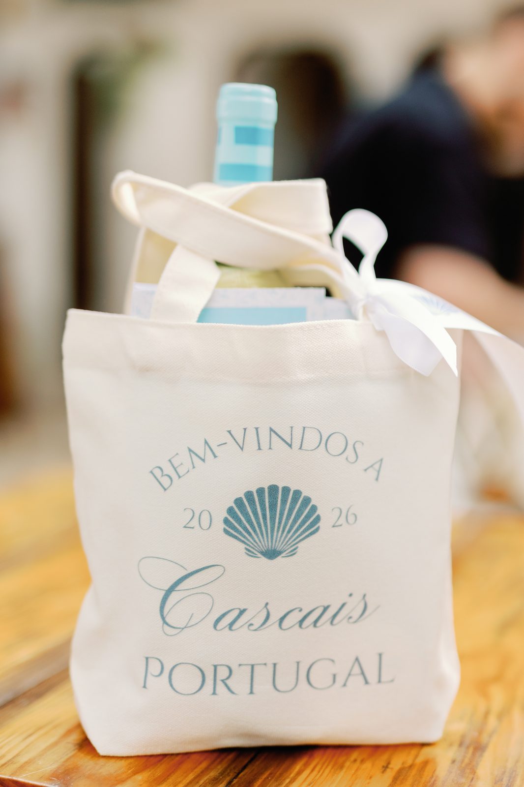 Close-up of a personalized welcome bag with wine bottle